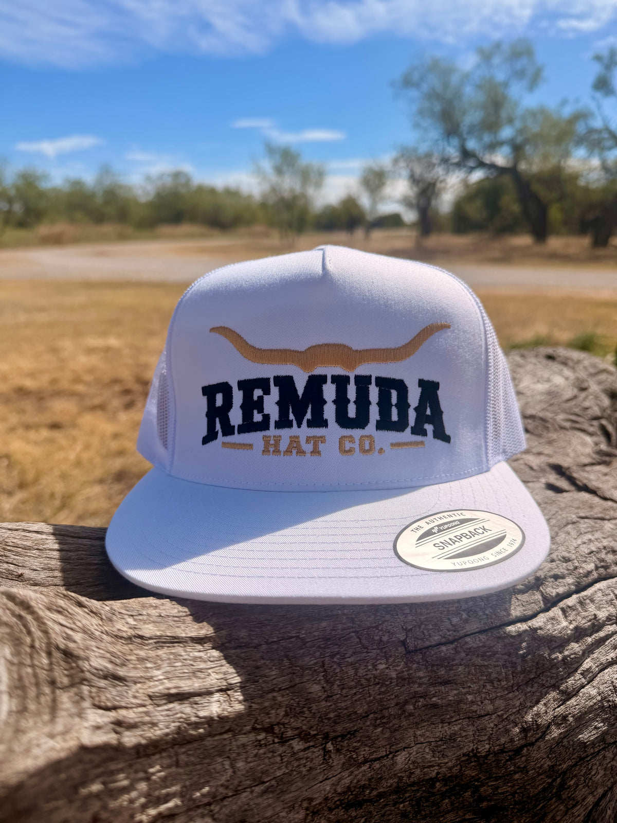 Front view of the white Remuda Longhorn Trucker Hat with black Remuda lettering and tan longhorn embroidery