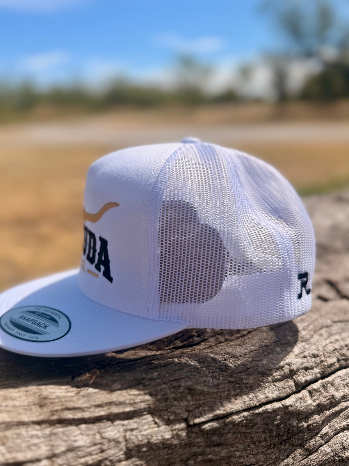 Side view of the white Remuda Longhorn Trucker Hat showing the mesh back and embroidered maker’s mark